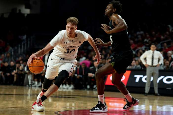 Cincinnati Bearcats forward Viktor Lakhin (30) drives on Cleveland State Vikings forward Deante Johnson (35) in the first half of the men s NCAA basketball game between the Cincinnati Bearcats and the Cleveland State Vikings at Fifth Third Arena in Cincinnati on Thursday, Nov. 10, 2022. Cleveland State Vikings At Cincinnati Bearcats